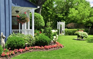 Landscaped front yard of a house with flowers and green lawn