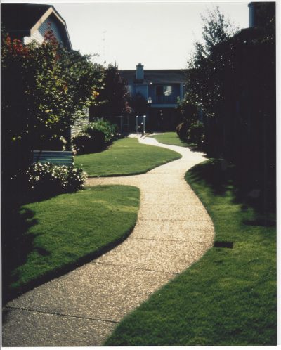 Stone walkway heading towards homes